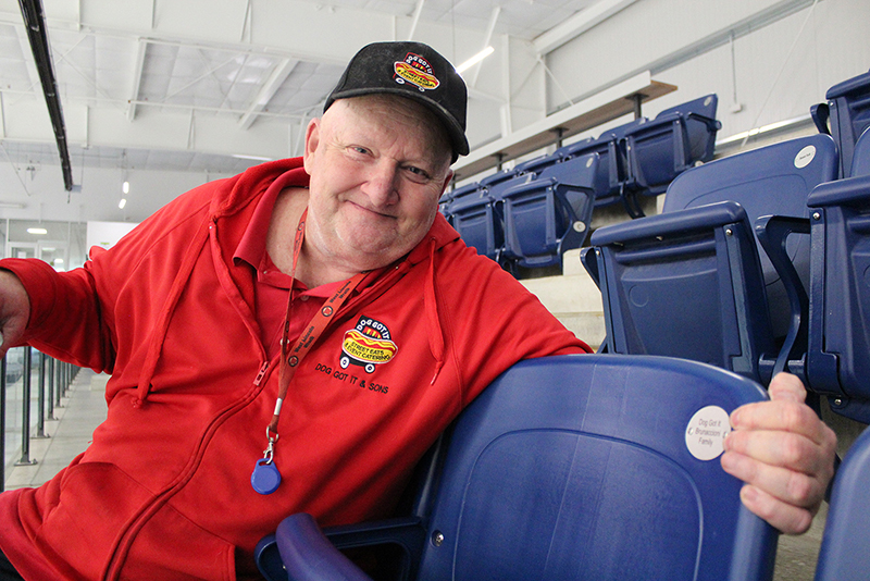 Man in red sweater sitting on arena seat
