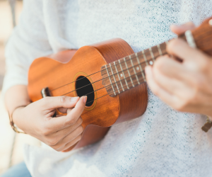 Photo of a person playing ukulele