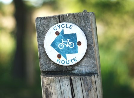 Close up of cycling route sign on wooden post