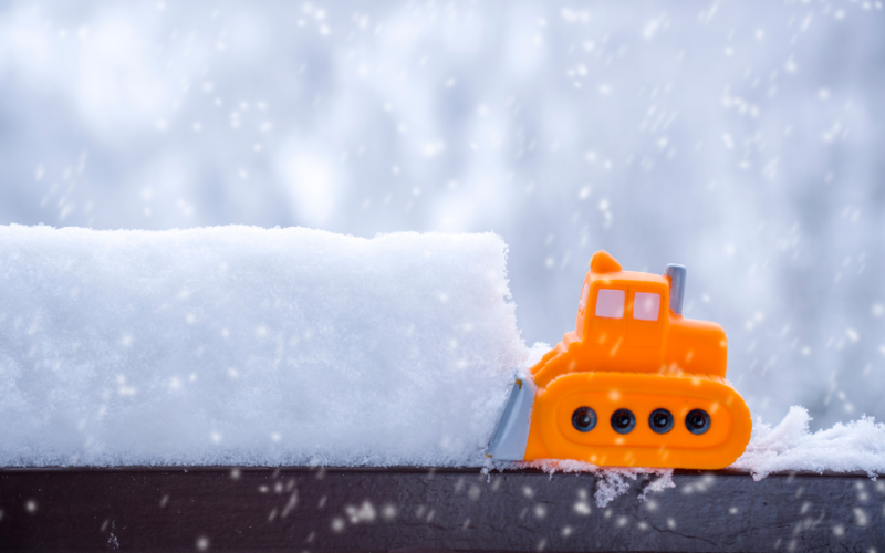 Toy snow plow pushing a pile of snow