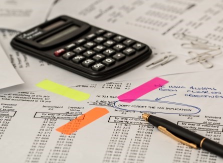 close up of calculator on desk with tax documents