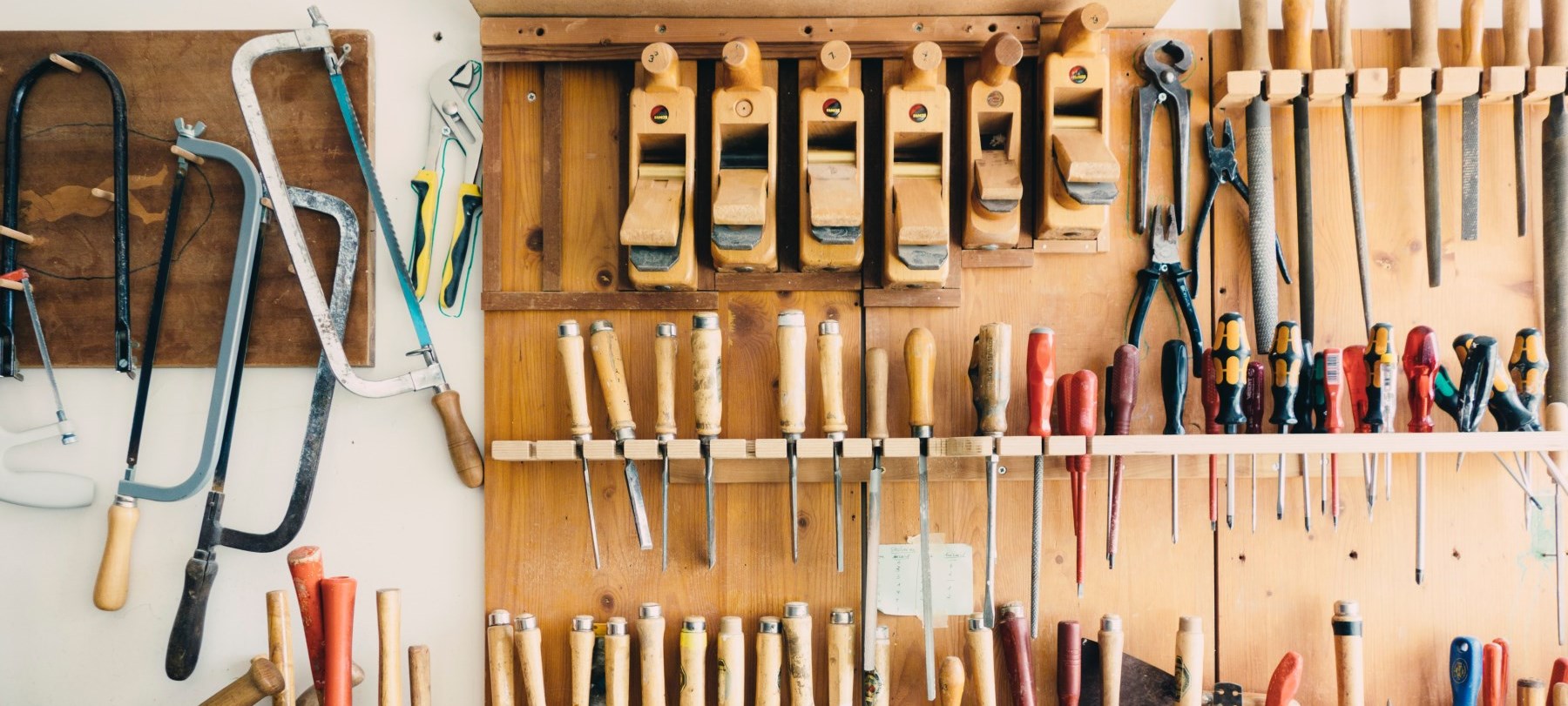 variety of building tools on wall in garage