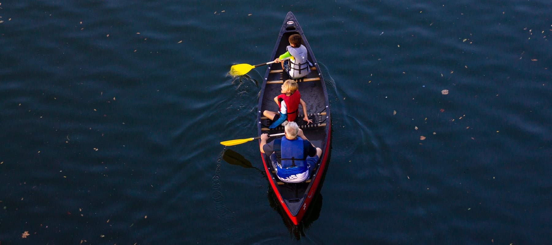 children in a canoe on the lake