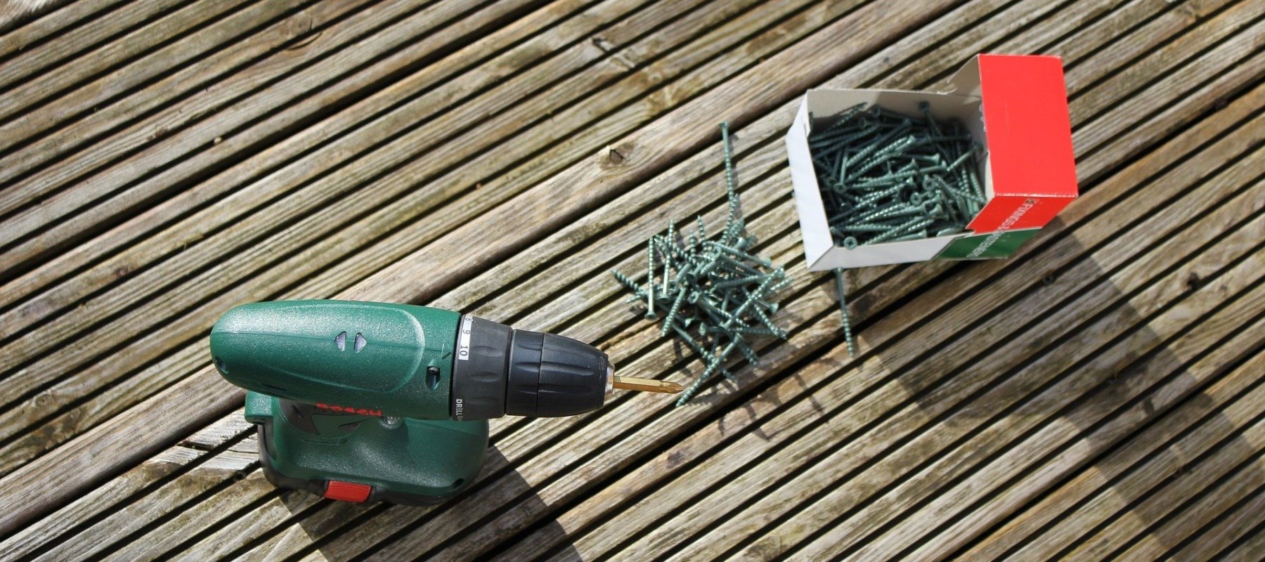 Drill and screws on wooden deck