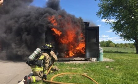 firefighters fighting shed fire