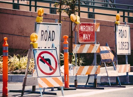 Assortment of road signage on sidewalk