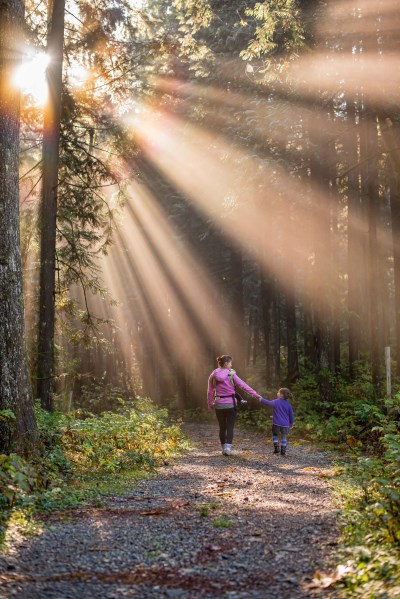 Mother and daughter walking on trail