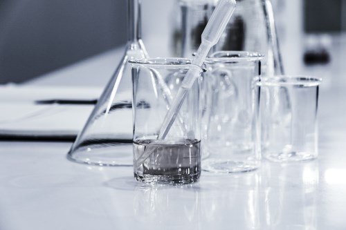 water in glass beaker with eyedropper in lab