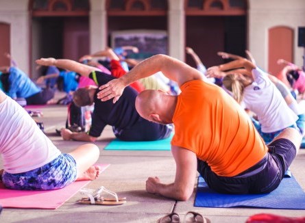 Group of adults stretching in a yoga class