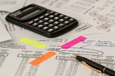 close up of calculator on desk with tax documents