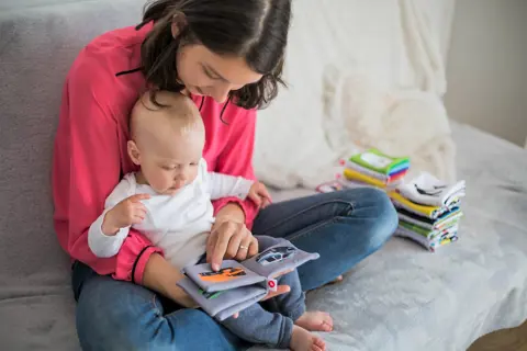 Young person reading book to child